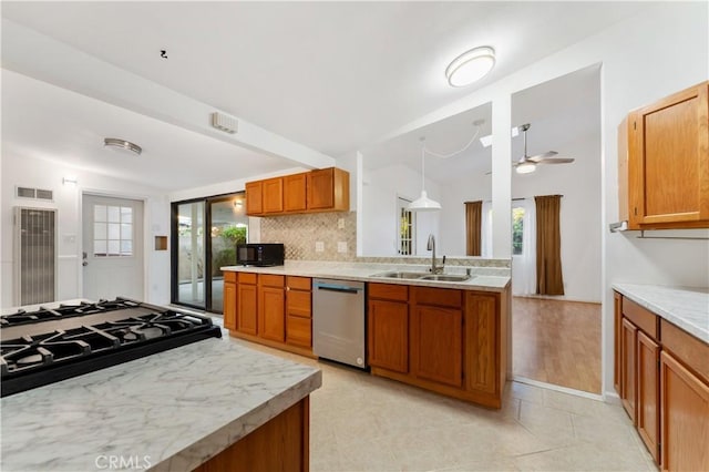 kitchen with a wealth of natural light, sink, ceiling fan, and stainless steel dishwasher