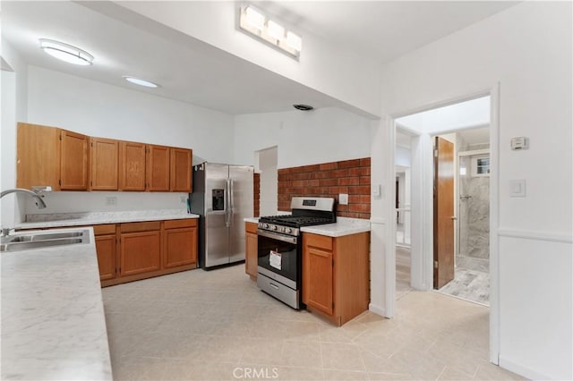 kitchen with sink, light tile patterned floors, and appliances with stainless steel finishes