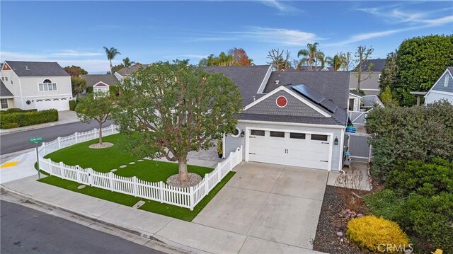 view of front of home featuring a garage and a front lawn