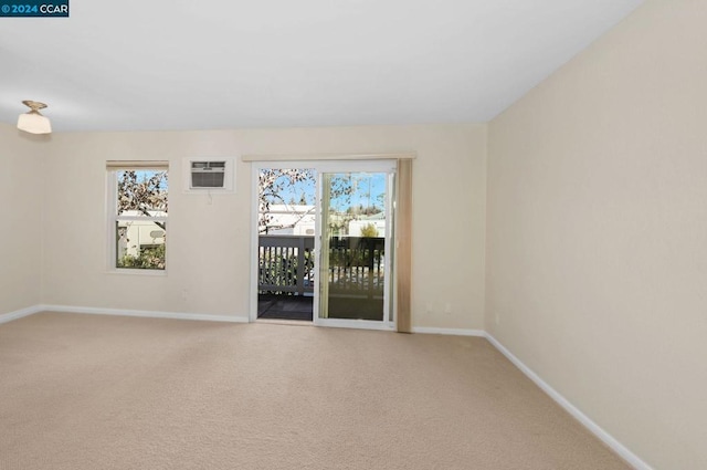 spare room with carpet floors and a wall mounted air conditioner