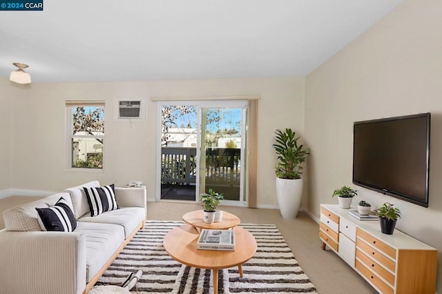 carpeted living room featuring an AC wall unit