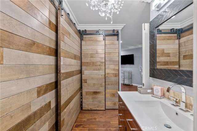 bathroom featuring hardwood / wood-style floors, vanity, and ornamental molding