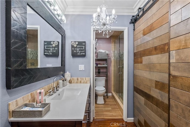 bathroom featuring vanity, toilet, crown molding, and an inviting chandelier