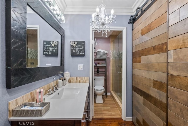 bathroom with vanity, crown molding, wood-type flooring, and toilet