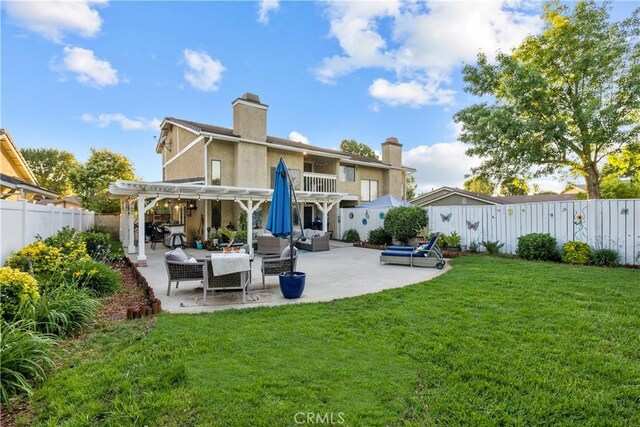 rear view of house with a lawn, an outdoor hangout area, a patio area, and a pergola