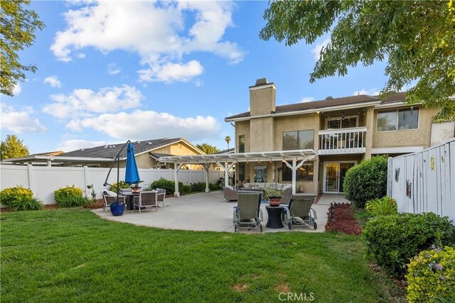 back of house with a lawn, a patio area, and a pergola