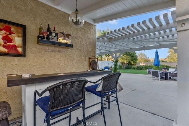 view of patio / terrace featuring a pergola and a bar