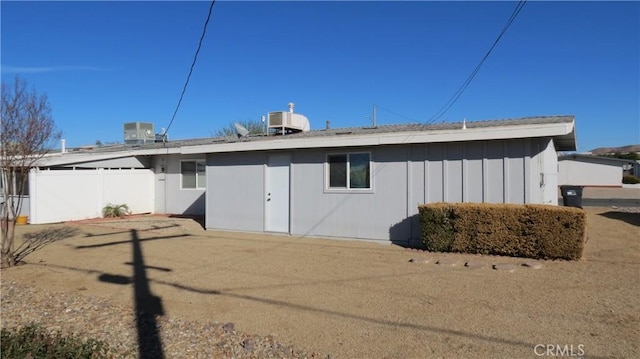 back of house featuring cooling unit