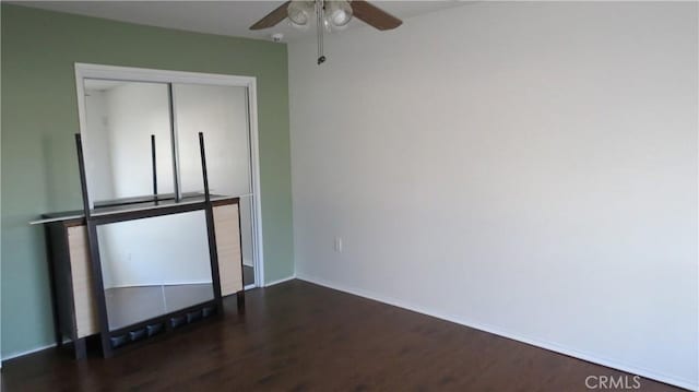 interior space with ceiling fan and dark hardwood / wood-style floors