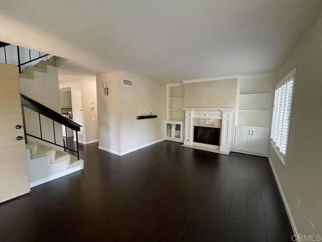 unfurnished living room featuring dark hardwood / wood-style flooring