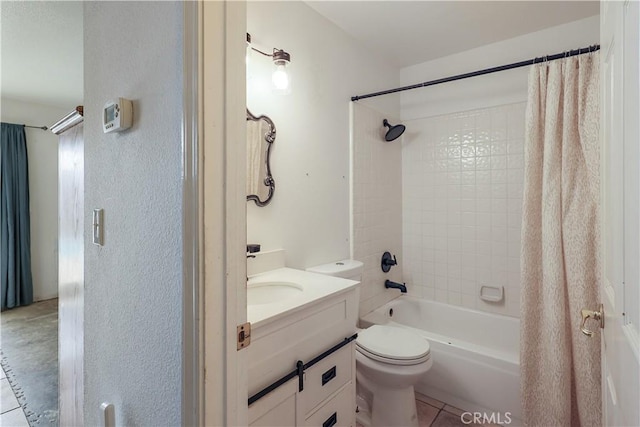 full bathroom with tile patterned floors, shower / bathtub combination with curtain, vanity, and toilet