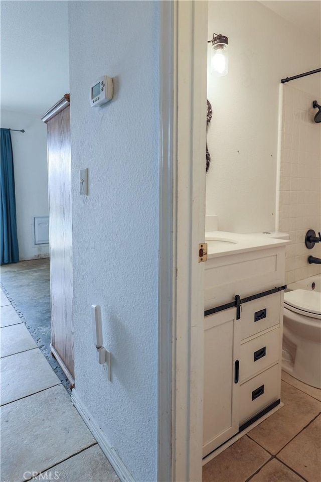 full bathroom featuring tile patterned flooring, vanity, shower / bath combination, and toilet