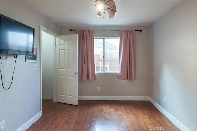 unfurnished bedroom with dark hardwood / wood-style flooring