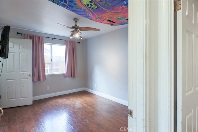 unfurnished bedroom featuring ceiling fan and dark wood-type flooring