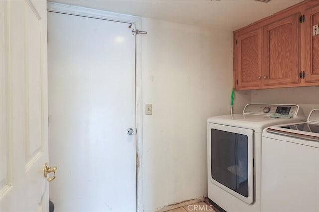 laundry room with washer and clothes dryer and cabinets