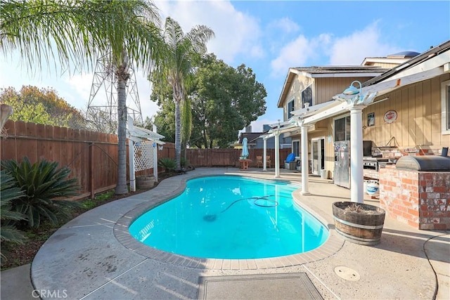 view of pool featuring a patio area and a grill