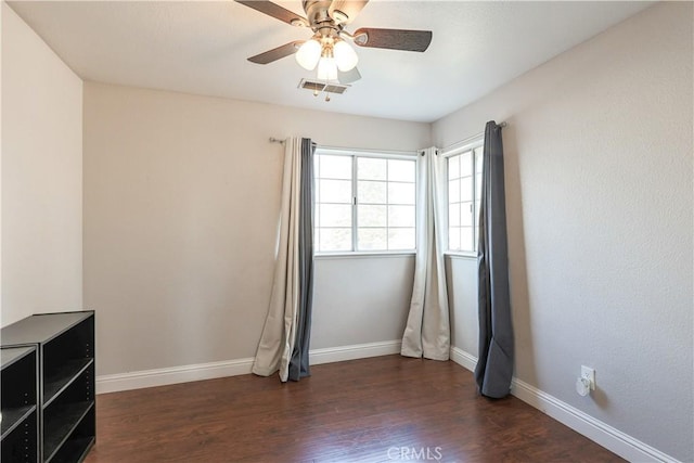 unfurnished room with ceiling fan and dark hardwood / wood-style flooring