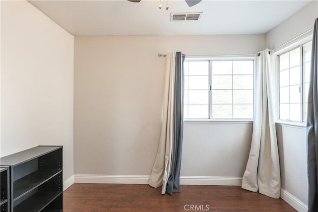 interior space featuring ceiling fan and dark hardwood / wood-style flooring