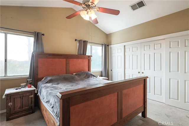 bedroom with ceiling fan, light carpet, and vaulted ceiling