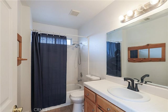 full bathroom with tile patterned flooring, shower / bath combo with shower curtain, vanity, and toilet