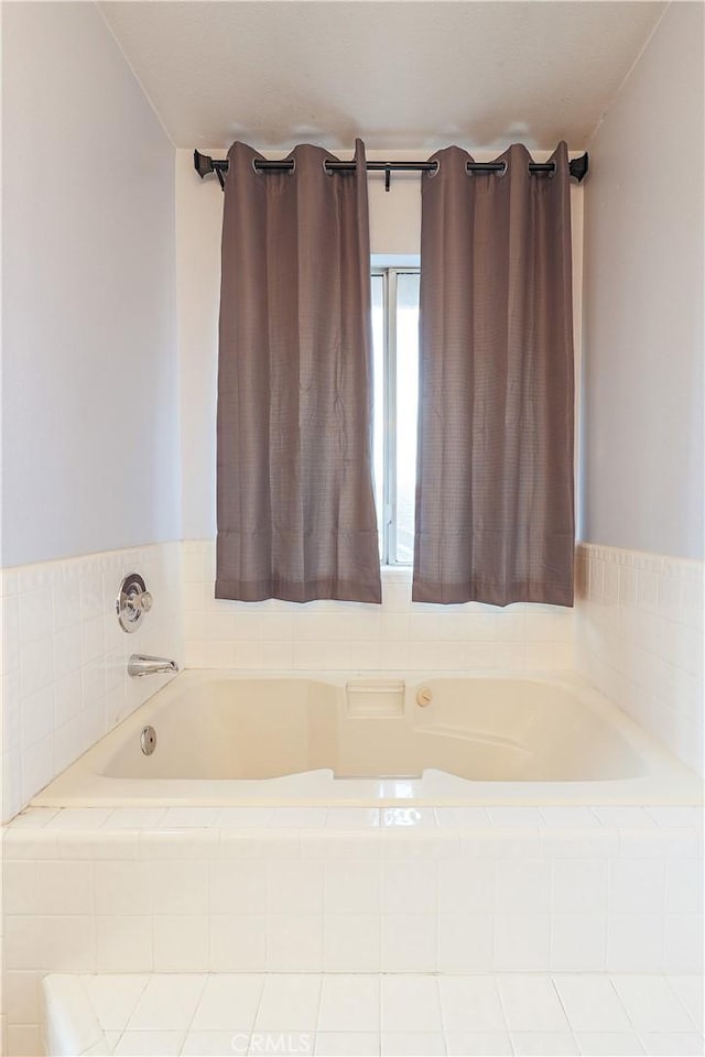 bathroom with tiled tub