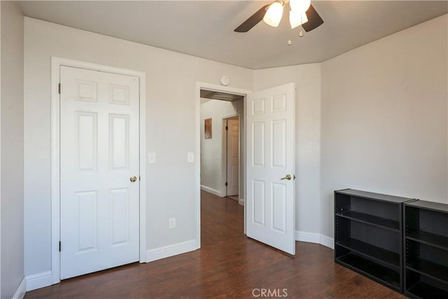 unfurnished bedroom featuring dark hardwood / wood-style floors and ceiling fan