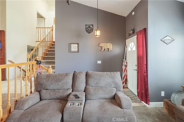 living room with carpet floors and high vaulted ceiling