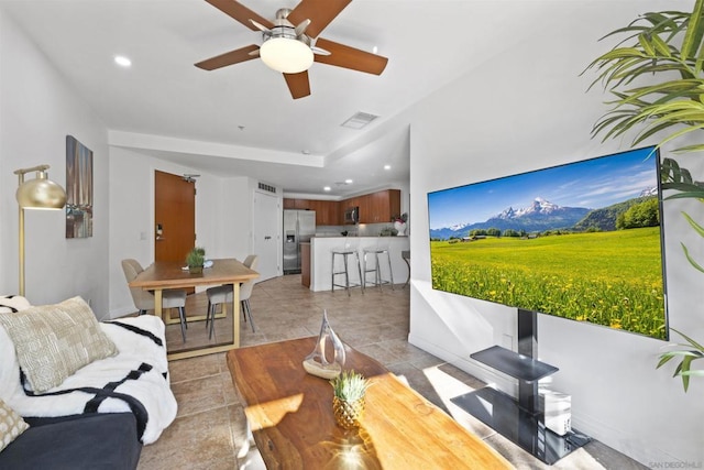 tiled living room featuring ceiling fan