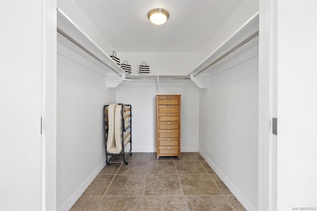 walk in closet with tile patterned flooring