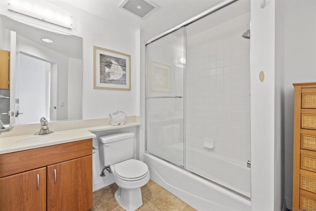 full bathroom with tile patterned floors, vanity, toilet, and enclosed tub / shower combo