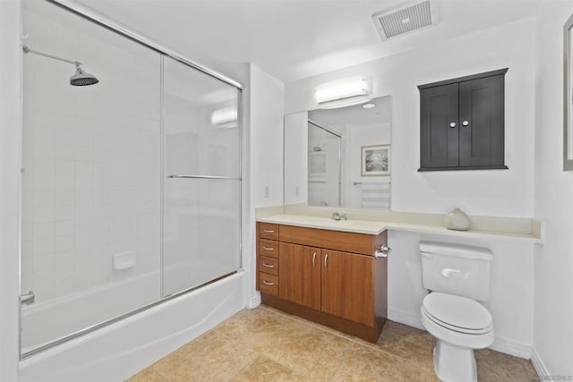 full bathroom featuring tile patterned floors, vanity, toilet, and shower / bath combination with glass door