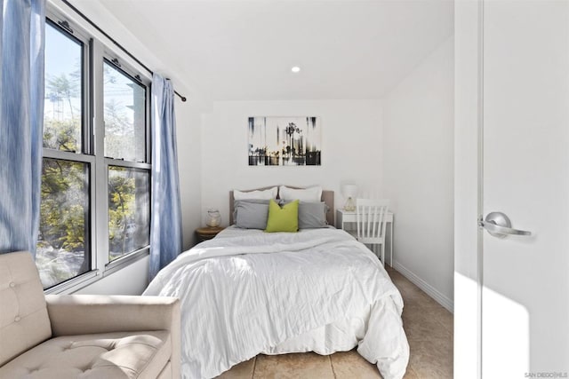 bedroom featuring multiple windows and tile patterned flooring