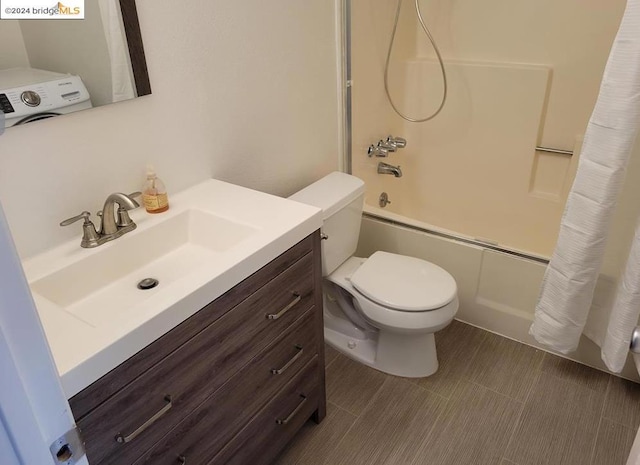 full bathroom featuring vanity, washer / clothes dryer, toilet, and tub / shower combination