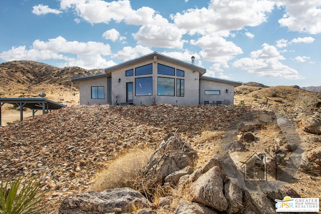 back of house featuring a mountain view