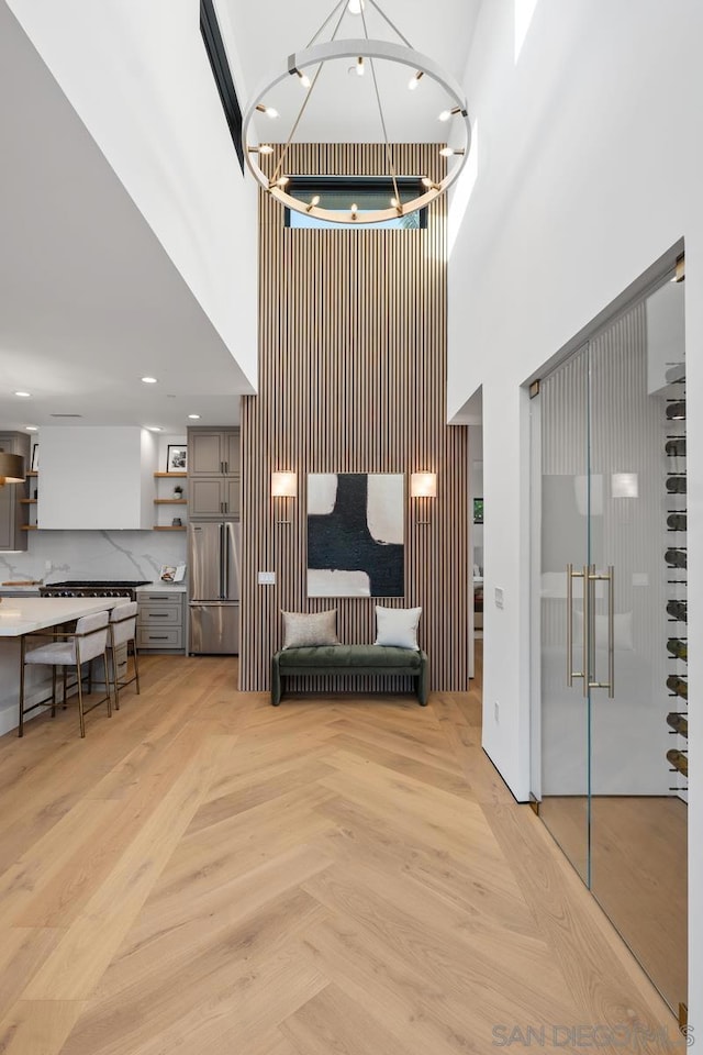 interior space featuring a towering ceiling and light parquet floors