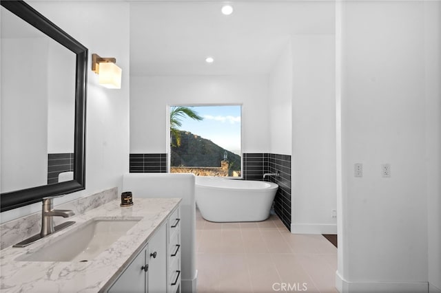 bathroom with vanity and a tub to relax in