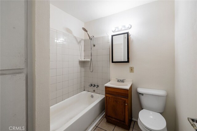 full bathroom with toilet, vanity, tiled shower / bath combo, and tile patterned floors