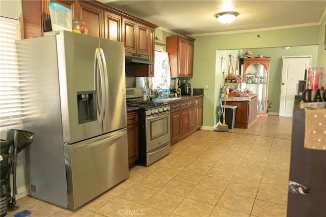 kitchen with appliances with stainless steel finishes, a textured ceiling, crown molding, and light tile patterned flooring