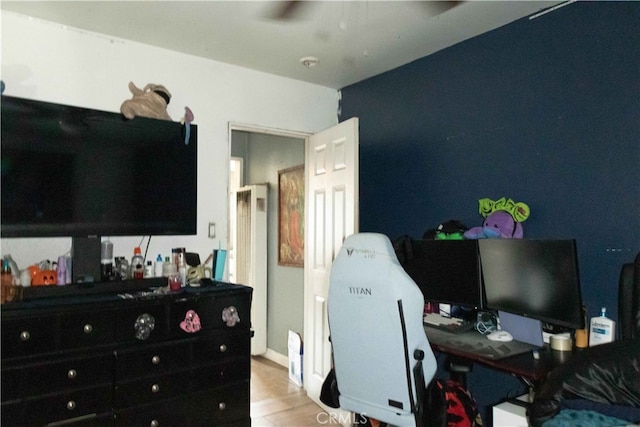 home office with light hardwood / wood-style flooring