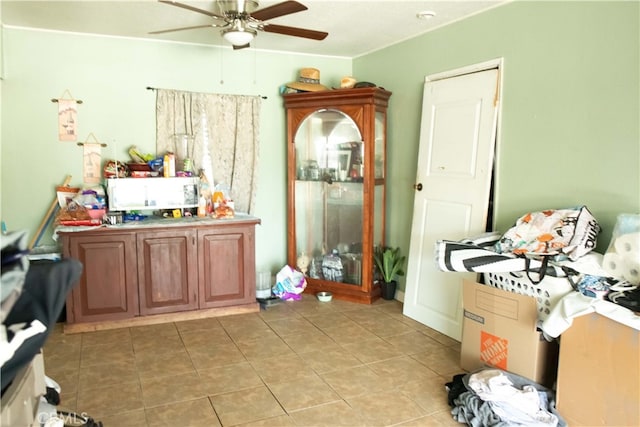 interior space featuring tile patterned floors and ceiling fan