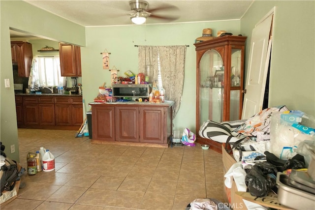 kitchen featuring ceiling fan and light tile patterned floors