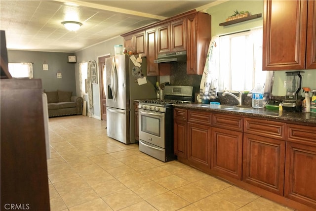 kitchen with light tile patterned floors, sink, stainless steel appliances, and dark stone countertops