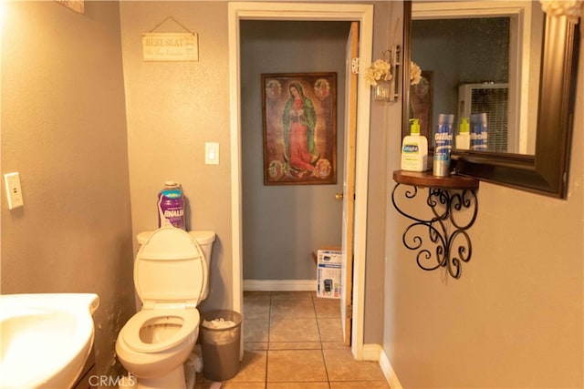 bathroom with sink, tile patterned flooring, and toilet