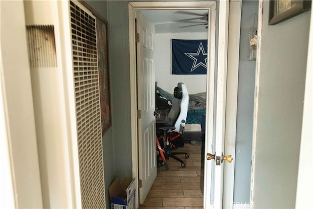 hallway with hardwood / wood-style flooring