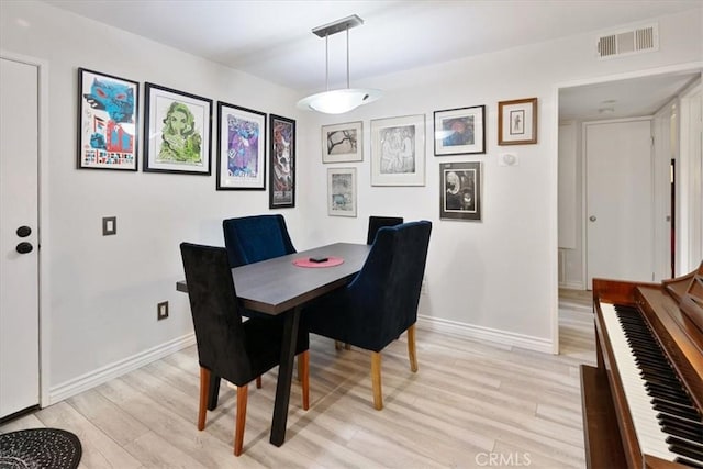 dining area with light hardwood / wood-style floors