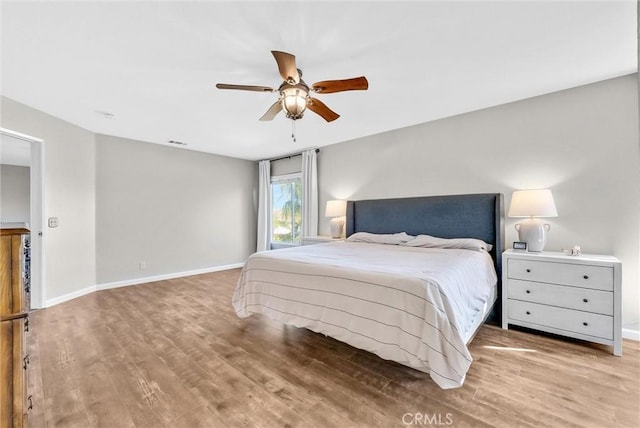 bedroom featuring hardwood / wood-style flooring and ceiling fan