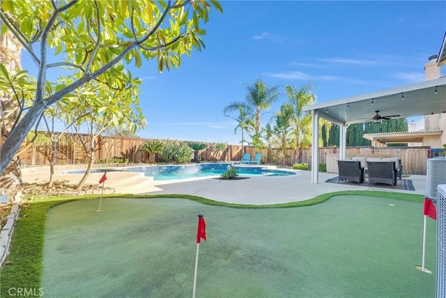 view of swimming pool featuring a patio area and ceiling fan