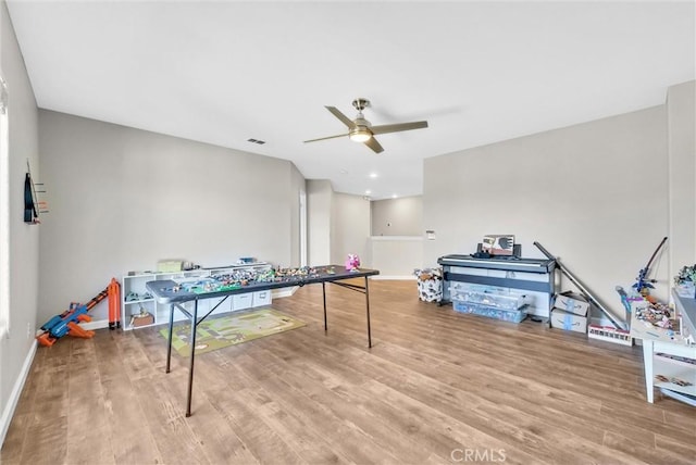 playroom featuring hardwood / wood-style flooring and ceiling fan