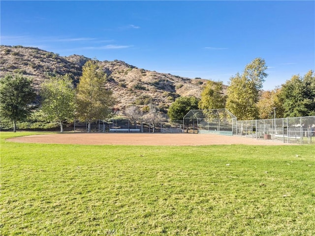 exterior space featuring a mountain view, a rural view, and a yard