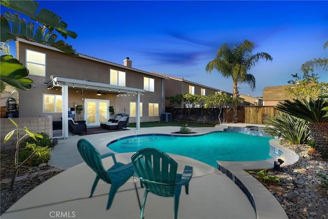 pool at dusk featuring french doors, central AC, ceiling fan, and a patio area